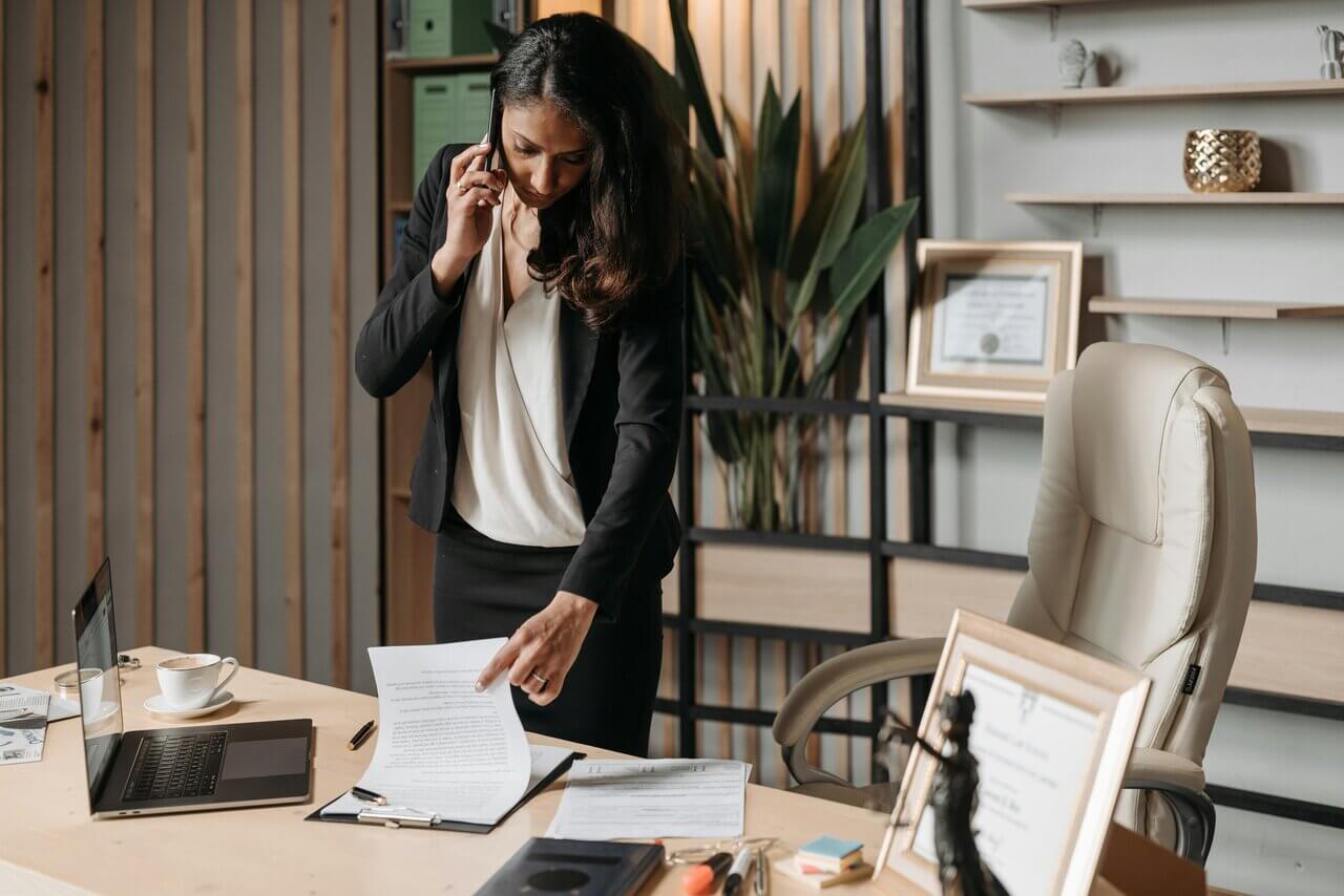 Female AAT-qualified bookkeeping professional on the phone at work 